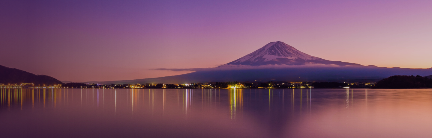 Mount Fuji at dusk across a lake.