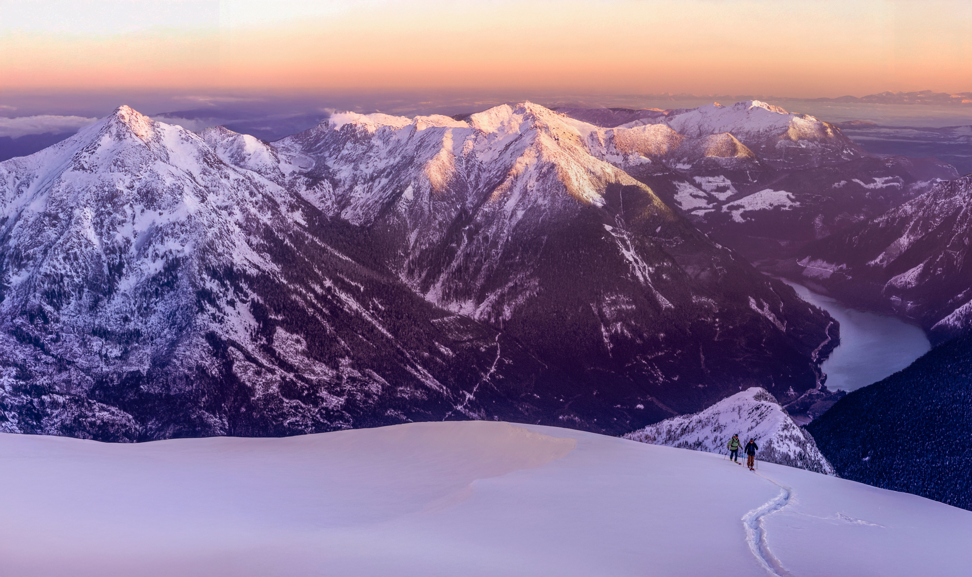 Snow-covered mountains at sunrise.